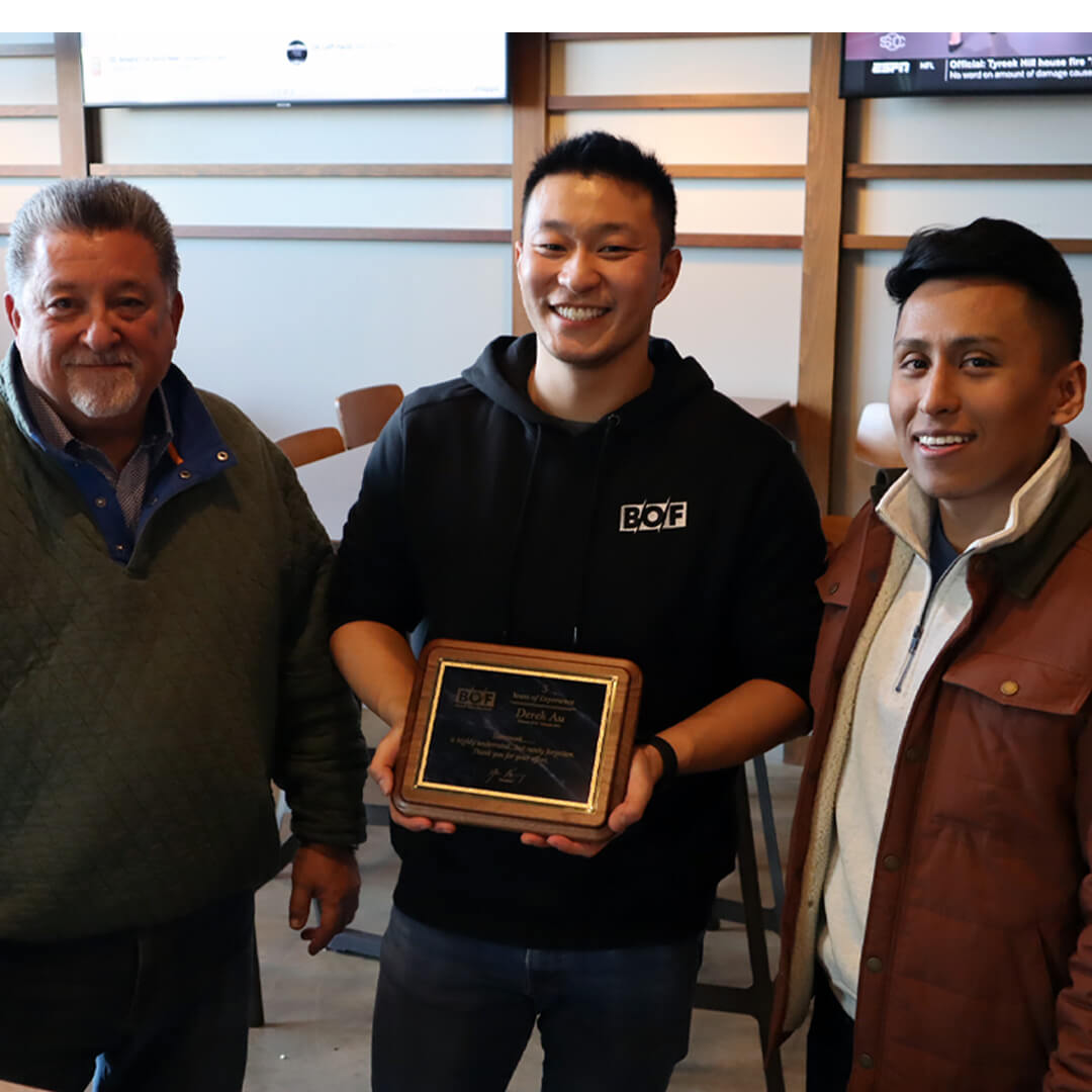 BOF's 2024 trip to Whirlyball. BOF staff members holding an award.