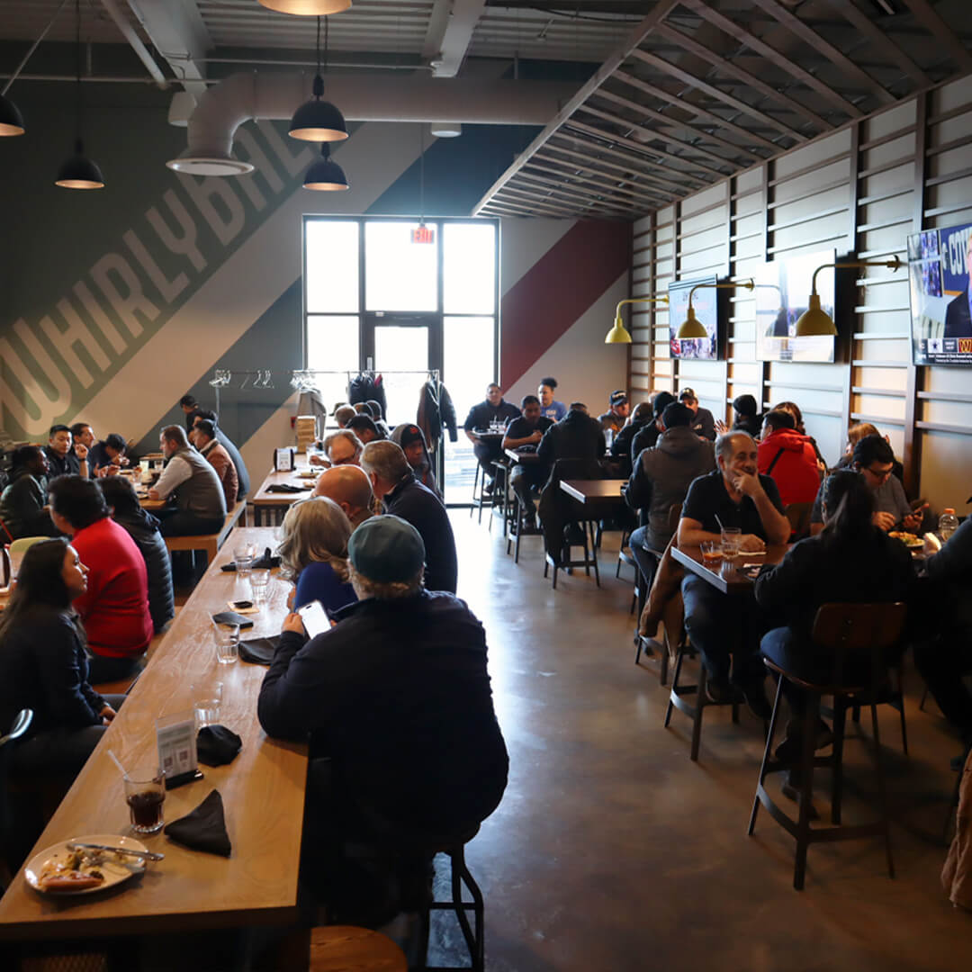 BOF's 2024 trip to Whirlyball. BOF staff sitting on tables.