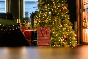 A Christmas tree indoors with presents in front of it