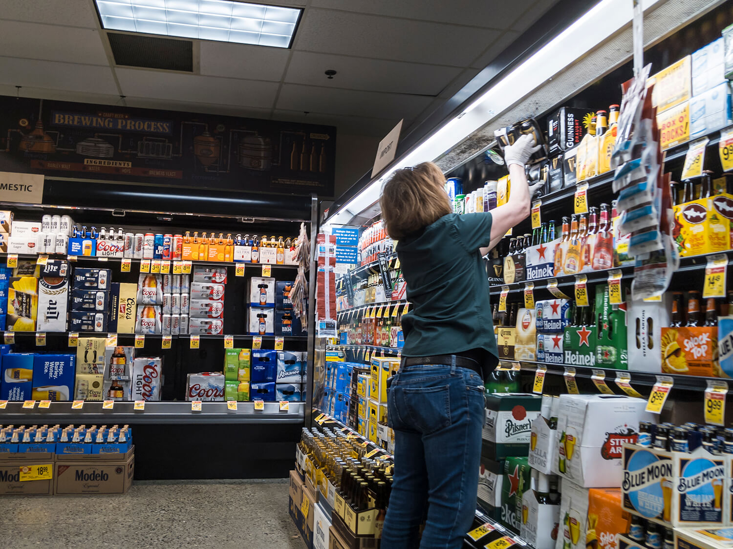 Grocery store worker stacking shelves